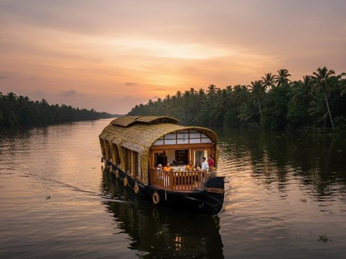 Traditional Kerala houseboat cruising through Kumarakom
